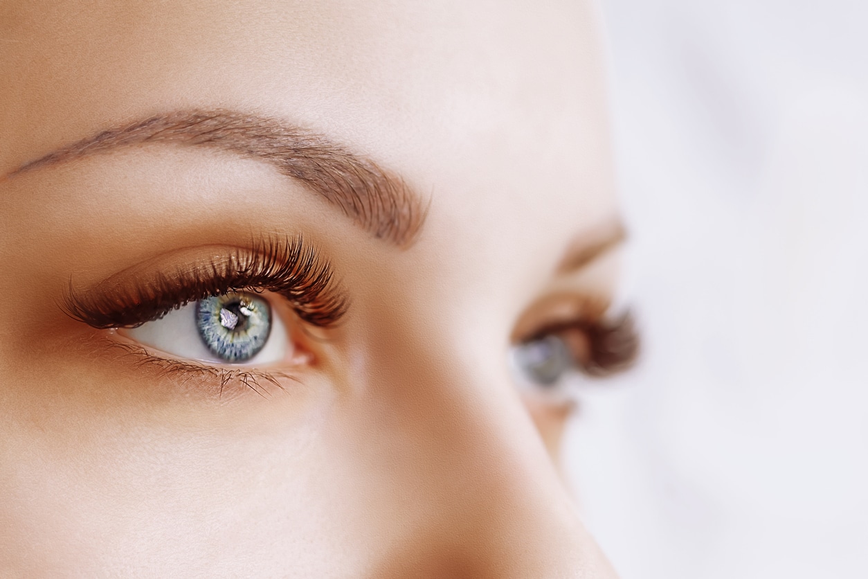 Eyelash Extension Procedure. Woman Eye with Long Eyelashes. Lashes. Close up, macro, selective focus